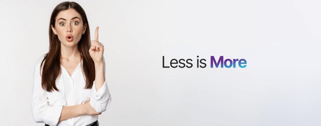 Enthusiastic young businesswoman in white collared shirt pointing upwards, looking directly at the camera, with 'Less is More' text in the background.